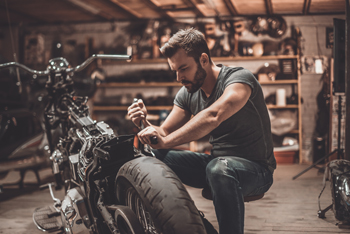 Man working on a motorcycle in a shop