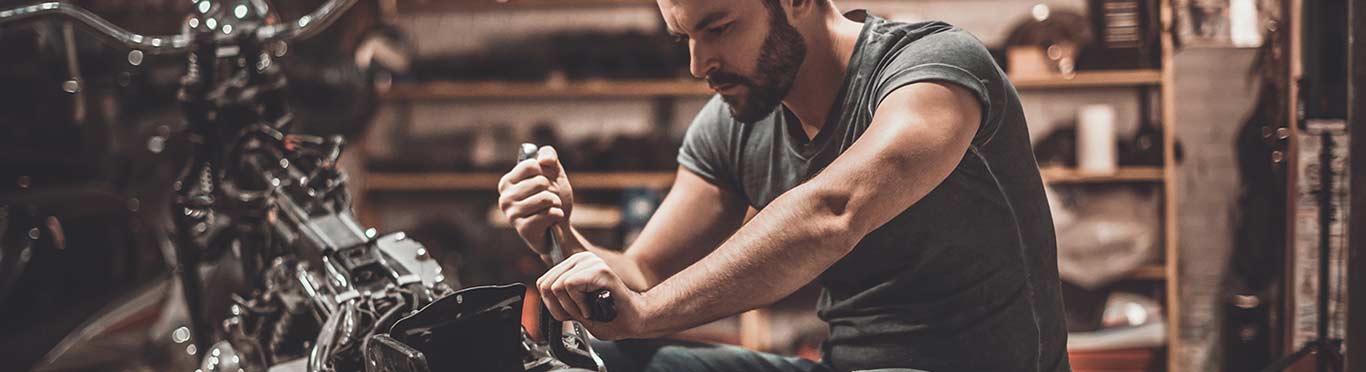 Man working on a motorcycle in a shop