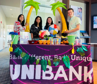 UniBank Sutton team in front of a decorated table
