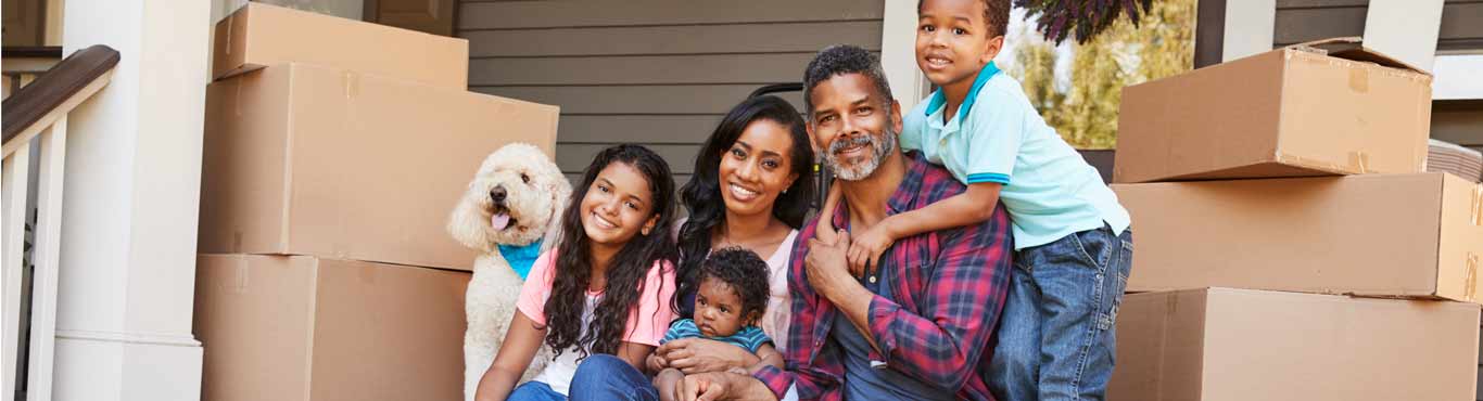 Family sitting on steps of home