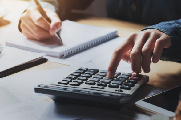 Person using a calculator and writing