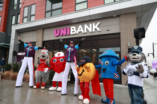 WooSox mascots and stilt walkers in front of UniBank Polar Park branch