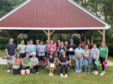 UniBank group posed with disc golf frisbees during disc golf night